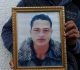 (FILES) This file photo taken on December 23, 2016 shows Walid Amri (back), the brother of 24-year-old Anis Amri, the suspected Berlin truck attacker, posing with a portrait of his brother Anis in front of the family house in the town of Oueslatia, in Tunisia's region of Kairouan.
German police on December 28, 2016 detained a Tunisian national on suspicion of having ties to Anis Amri, the suspected Berlin truck attacker gunned down by Italian police, prosecutors said. Twelve people were killed and dozens injured on December 19, when Amri is believed to have hijacked a truck and used it to mow down people at a Berlin Christmas market.
 / AFP PHOTO / FETHI BELAID