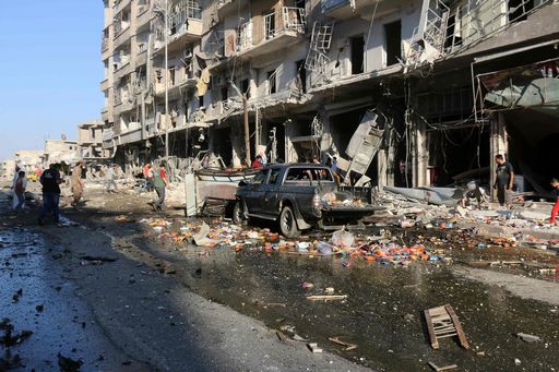 Syrians inspect the damage on a street following a reported airstrike at a market in the rebel-held district of Tariq al-Bab, in the northern city of Aleppo on July 1, 2016. 
Separate air raids in northern Syria by regime aircraft and warplanes of the US-led international coalition killed at least 25 civilians, a monitoring group said. President Bashar al-Assad's air force attacked a crowded market in Aleppo city's rebel-held district of Tariq al-Bab, killing 11 people, the Syrian Observatory for Human Rights reported.

 / AFP PHOTO / THAER MOHAMMED