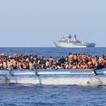 In a handout picture released by the British Ministry of Defence (MOD) via their Defence News Imagery website on May 28, 2015 hundreds of migrants in a wooden-hulled ship are seen wearing lifejackets provided by Royal Navy personnel from British Royal Navy Albion-class assault ship HMS Bulwark (background) during a rescue mission in the Mediterranean Sea just north of the coast of Libya on May 28, 2015. Royal Navy personnel from HMS Bulwark were involved in an international rescue of hundreds of migrants from their stricken craft in the Central Mediterranean. 369 migrants crammed into a heavily overcrowded boat just north of Libya were led to safety from their stricken boat to landing craft from HMS Bulwark that have been converted into rescue boats loaded with lifejackets, medical facilities and emergency supplies. RESTRICTED TO EDITORIAL USE - MANDATORY CREDIT  " AFP PHOTO / ROYAL NAVY / MOD / CROWN COPYRIGHT 2015 / ET WE(CIS) LOUISE GEORGE "  -  NO MARKETING NO ADVERTISING CAMPAIGNS   -   DISTRIBUTED AS A SERVICE TO CLIENTS  -  NO ARCHIVE - TO BE USED WITHIN 2 DAYS (48 HOURS) FROM MAY 28, 2015, EXCEPT FOR MAGAZINES WHICH CAN PRINT THE PICTURE WHEN FIRST REPORTING ON THE EVENT