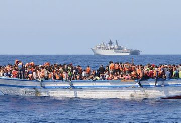 In a handout picture released by the British Ministry of Defence (MOD) via their Defence News Imagery website on May 28, 2015 hundreds of migrants in a wooden-hulled ship are seen wearing lifejackets provided by Royal Navy personnel from British Royal Navy Albion-class assault ship HMS Bulwark (background) during a rescue mission in the Mediterranean Sea just north of the coast of Libya on May 28, 2015. Royal Navy personnel from HMS Bulwark were involved in an international rescue of hundreds of migrants from their stricken craft in the Central Mediterranean. 369 migrants crammed into a heavily overcrowded boat just north of Libya were led to safety from their stricken boat to landing craft from HMS Bulwark that have been converted into rescue boats loaded with lifejackets, medical facilities and emergency supplies. RESTRICTED TO EDITORIAL USE - MANDATORY CREDIT  " AFP PHOTO / ROYAL NAVY / MOD / CROWN COPYRIGHT 2015 / ET WE(CIS) LOUISE GEORGE "  -  NO MARKETING NO ADVERTISING CAMPAIGNS   -   DISTRIBUTED AS A SERVICE TO CLIENTS  -  NO ARCHIVE - TO BE USED WITHIN 2 DAYS (48 HOURS) FROM MAY 28, 2015, EXCEPT FOR MAGAZINES WHICH CAN PRINT THE PICTURE WHEN FIRST REPORTING ON THE EVENT