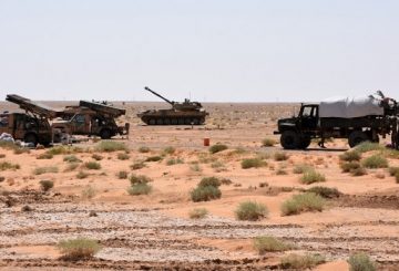 A picture taken on September 3, 2017 shows Syrian army artillery vehicles and rocket launchers stationed near the village of Huraybishah, within the administrative borders of Syria's eastern Deir Ezzor province. / AFP PHOTO / George OURFALIAN
