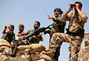 Kurdish peshmerga fighters take position in Bashiqa, near Mosul.