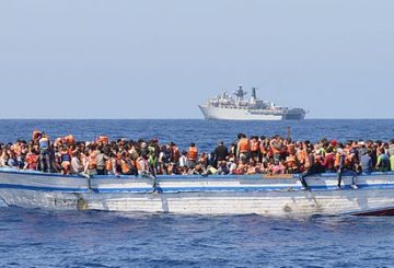 In a handout picture released by the British Ministry of Defence (MOD) via their Defence News Imagery website on May 28, 2015 hundreds of migrants in a wooden-hulled ship are seen wearing lifejackets provided by Royal Navy personnel from British Royal Navy Albion-class assault ship HMS Bulwark (background) during a rescue mission in the Mediterranean Sea just north of the coast of Libya on May 28, 2015. Royal Navy personnel from HMS Bulwark were involved in an international rescue of hundreds of migrants from their stricken craft in the Central Mediterranean. 369 migrants crammed into a heavily overcrowded boat just north of Libya were led to safety from their stricken boat to landing craft from HMS Bulwark that have been converted into rescue boats loaded with lifejackets, medical facilities and emergency supplies. RESTRICTED TO EDITORIAL USE - MANDATORY CREDIT " AFP PHOTO / ROYAL NAVY / MOD / CROWN COPYRIGHT 2015 / ET WE(CIS) LOUISE GEORGE " - NO MARKETING NO ADVERTISING CAMPAIGNS - DISTRIBUTED AS A SERVICE TO CLIENTS - NO ARCHIVE - TO BE USED WITHIN 2 DAYS (48 HOURS) FROM MAY 28, 2015, EXCEPT FOR MAGAZINES WHICH CAN PRINT THE PICTURE WHEN FIRST REPORTING ON THE EVENT