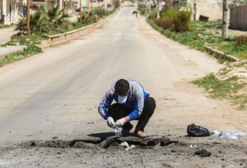 A Syrian man collects samples from the site of a suspected toxic gas attack in Khan Sheikhun, in Syrias northwestern Idlib province, on April 5, 2017. International outrage is mounting over a suspected chemical attack that killed scores of civilians in Khan Sheikhun on April 4, 2017. / AFP PHOTO / Omar haj kadour (Photo credit should read OMAR HAJ KADOUR/AFP/Getty Images)