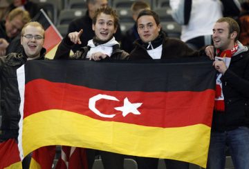 Soccer fans pose before the Euro 2012 qualifying soccer match between Turkey and Germany at the Olympic stadium in Berlin October 8, 2010. REUTERS/Thomas Peter (GERMANY - Tags: SPORT SOCCER)