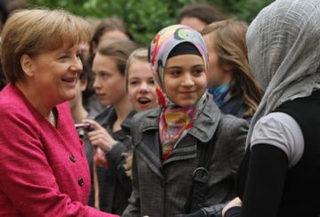 BERLIN, GERMANY - MAY 16: German Chancellor Angela Merkel greets students at the Sophie Scholl school during a visit on the fifth European Union school project day on May 16, 2011 in Berlin, Germany. The nationwide initiative is meant to foster a stronger understanding young people of the role of the European Union. (Photo by Sean Gallup/Getty Images)