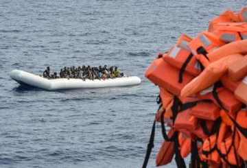 (FILES) This file photo taken on November 05, 2016 shows migrants and refugees on a rubber boat waiting to be evacuated during a rescue operation by the crew of the Topaz Responder, a rescue ship run by Maltese NGO "Moas" and the Red Cross, on November 5, 2016 off the coast of Libya. Italian Foreign Minister Angelino Alfano on April 29, 2017 said he "agreed 100 percent" with a prosecutor Carmelo Zuccaro who has repeatedly suggested charity boats rescuing migrants in the Mediterranean are colluding with traffickers in Libya. / AFP PHOTO / ANDREAS SOLARO