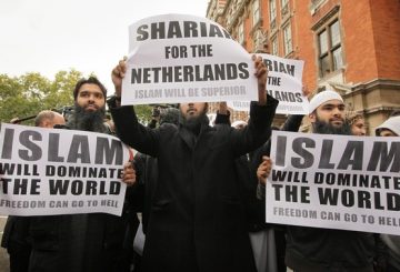 LONDON, ENGLAND - OCTOBER 16: Protestors hold placards outside a press conference being held by right-wing Dutch MP Geert Wilders on October 16, 2009 in London. Mr Wilders was allowed into the UK after he overturned a previous ban by the UK immigration authorities. About 20 protestors gathered outside the building where he held a press conference. (Photo by Peter Macdiarmid/Getty Images)