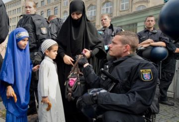 german-police-officer-checks-the-bag-of-a-female-supporter-of-pierre-vogel-before-a-salafist-rally
