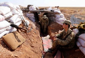 Syrian rebel-fighter from the National Liberation Front (NLF) man a position at the frontline facing regime areas in the southern countryside of Aleppo on October 14, 2018. - A deal was brokered by Syria's ally Russia and Turkey last month stipulating that rebel factions had until October 10 to withdraw heavy weaponry from a 15 to 20 kilometre (nine to 12 mile) wide buffer zone, which rings Idlib province and adjacent areas of the northwest, and October 15 for withdrawal of jihadist groups. (Photo by OMAR HAJ KADOUR / AFP)