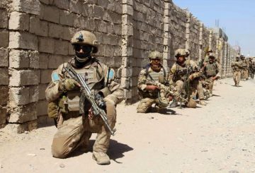 In this photograph taken on October 9, 2016, Afghan National Army commandos take position during a military operation in Helmand province. / AFP PHOTO / NOOR MOHAMMAD