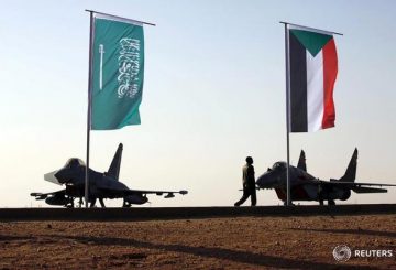 Military personnel walk past the flags of Saudi Arabia and Sudan as Sudan's President Omar Ahmed al-Bashir attends the final training exercise between the Saudi Air Force and Sudanese Air Forces at Merowe Airport in Merowe, Northern State, Sudan April 9, 2017. REUTERS/Mohamed Nureldin Abdallah - RTX34SBQ