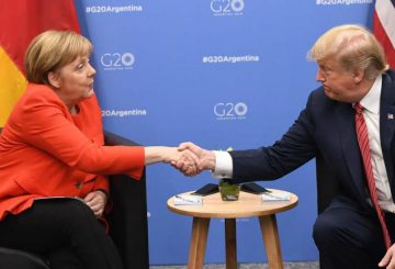 Germanyís Chancellor Angela Merkel (L) and US President Donald Trump shake hands during a bilateral meeting, on the sidelines of the G20 Leaders' Summit in Buenos Aires, on December 01, 2018. - The leaders of countries representing four-fifths of the global economy opened a two-day meeting in Argentina facing the deepest fractures since the first G20 summit convened 10 years ago in the throes of financial crisis. (Photo by SAUL LOEB / AFP)