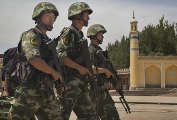 KASHGAR, CHINA - JULY 31: Chinese soldiers march in front of the Id Kah Mosque, China's largest, on July 31, 2014 in Kashgar, China. China has increased security in many parts of the restive Xinjiang province following some of the worst violence in months in the Uyghur dominated area. (Photo by Getty Images)