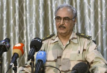 General Khalifa Haftar speaks during a news conference at a sports club in Abyar, a small town to the east of Benghazi. May 17, 2014. The self-declared Libyan National Army led by a renegade general told civilians on Saturday to leave parts of Benghazi before it launched a fresh attack on Islamist militants, a day after dozens were killed in the worst clashes in the city for months. Families could be seen packing up and driving away from western districts of the port city where Islamist militants and LNA forces led by retired General Haftar fought for hours on Friday, killing at least 43 people. REUTERS/Esam Omran Al-Fetori (LIBYA - Tags: CIVIL UNREST MILITARY POLITICS)