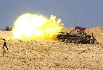 [Anti-Gaddafi fighters fire from tanks during clashes with pro-Gaddafi forces near Sirte, September 28, 2011. Sirte, one of the last bastions of support for Muammar Gaddafi, is encircled by forces of Libya's ruling National Transitional Council (NTC) and under bombardment from NATO warplanes. REUTERS/Asmaa Waguih (LIBYA - Tags: POLITICS CIVIL UNREST CONFLICT TPX IMAGES OF THE DAY)] *** []