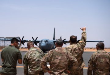 U.S. Air Force Airmen assigned to the 409th Air Expeditionary Group watch as a C-130J Super Hercules taxis in at Nigerien Air Base 201, Agadez, Niger, Aug. 3, 2019. The C-130 landing marked the next step in airfield evaluations by starting Visual Flight Rules operations at the base. (U.S. Air Force photo by Staff Sgt. Devin Boyer)