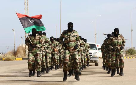 epa04486669 Libyan Army soldiers parade during a graduation ceremony of the first batch of the Tripoli air base security and protection batallion of the Presidency of the General Staff of the Libyan army, in Tripoli, Libya, 12 November 2014. EPA/STR