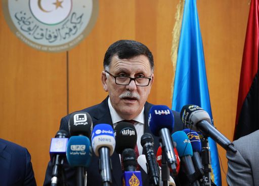 Libya's UN-backed Prime Minister-designate, Fayez al-Sarraj, flanked by members of the presidential council, speaks during a press conference on March 30, 2016 in the capital Tripoli. Fayez al-Sarraj arrived in Tripoli following months of mounting international pressure for the country's warring sides to allow him to start work. / AFP PHOTO / STRINGER