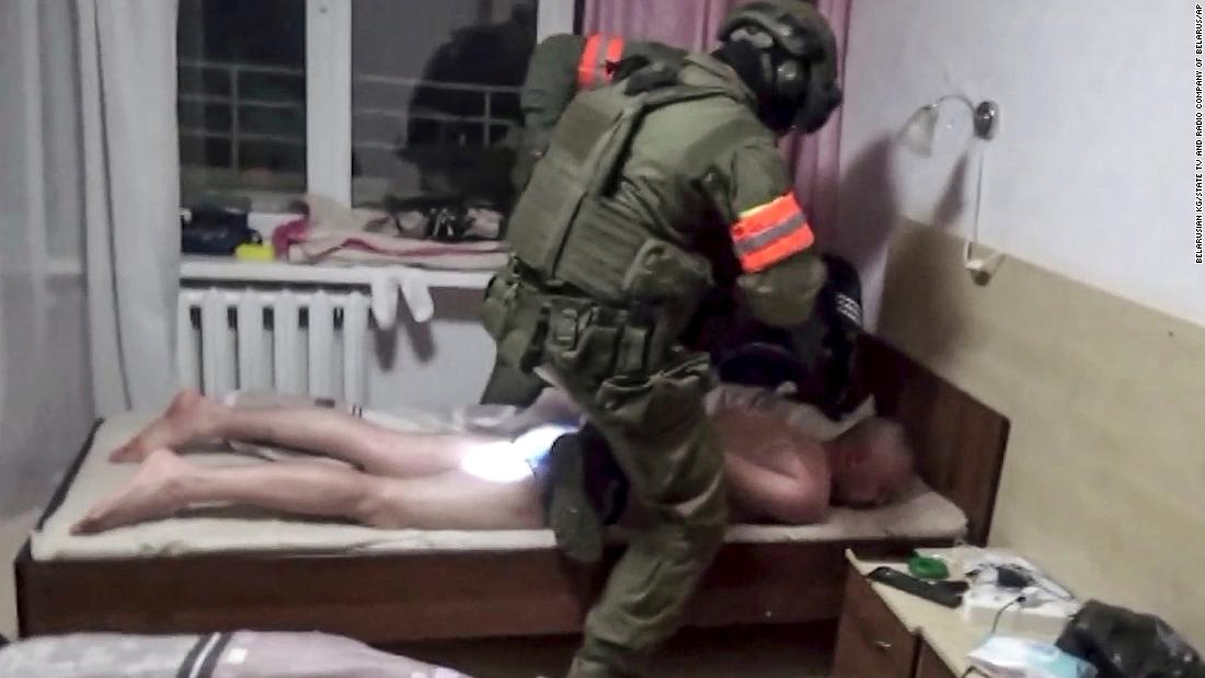 In this photo taken from video released by Belarusian KGB, State TV and Radio Company of Belarus on Wednesday, July 29, 2020, a Belarusian KGB officer detains a Russian man in a sanitarium outside in Minsk, Belarus. Belarusian officials said that more than 30 detained employees of private Russian military contractor Wagner are facing a criminal probe on charges of plotting terror attacks in Belarus amid a presidential election campaign. (Belarusian KGB, State TV and Radio Company of Belarus via AP)