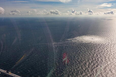 epa10209594 A handout photo taken from a Danish F-16 jet on 27 September 2022 and made available by the Danish Defence Command shows a gas leak of the Nord Stream 2 pipeline off Bornholm, Denmark, Baltic Sea. The Danish energy agency confirmed 27 September 2022 three gas leaks on the Nord Stream 1 and 2 pipelines. EPA/Danish Defence Command / HANDOUT HANDOUT EDITORIAL USE ONLY/NO SALES